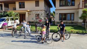 a group of people standing with bikes in front of a house at Elegancy Resort Hua Hin in Hua Hin