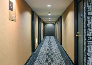 a corridor of a corridor with a long hallway at APA Hotel Nagasaki-eki Minami in Nagasaki