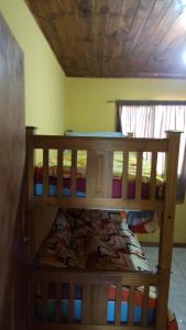 two bunk beds in a room with a ceiling at Hospedaje El TaTa in Colonia Las Rosas