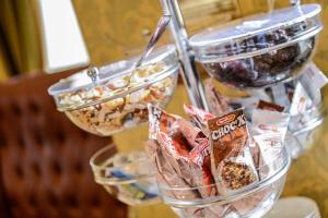 a group of containers of food on a rack at Albergo Alla Posta in Trieste