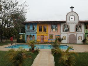a large house with a pool in front of it at Hotel Cabañas De Rozo in Rozo +25 photos