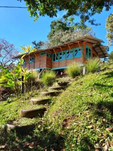 a house on a hill with stairs leading up to it at Casa de Bambú in Turrialba