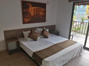 Llit o llits en una habitació de Hotel Cabañas De Rozo