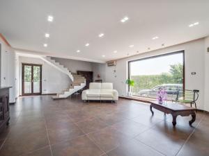 a large living room with a couch and a table at Belvilla by OYO Modern villa in Nissoria with pool in Nissoria