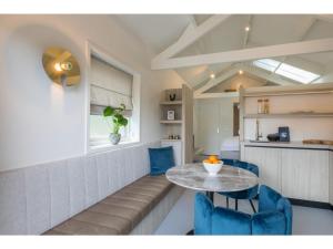 a dining room with a table and blue chairs at Luxury holiday home 250 meters from the beach in Domburg