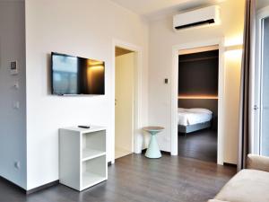 a living room with a bed and a tv on a wall at Classy Apartment in Venice near Venice Island in Venice