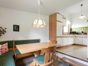 a kitchen and dining room with a wooden table at Holiday home in Bad Mitterndorf near ski area in Bad Mitterndorf