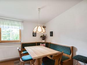 a dining room with a wooden table and chairs at Holiday home in Bad Mitterndorf near ski area in Bad Mitterndorf