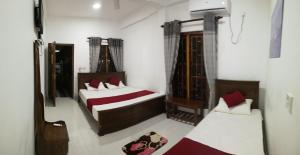Voodi või voodid majutusasutuse Dive beach palace toas