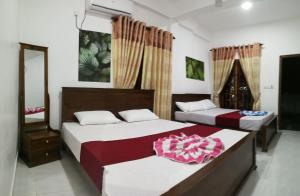 Voodi või voodid majutusasutuse Dive beach palace toas