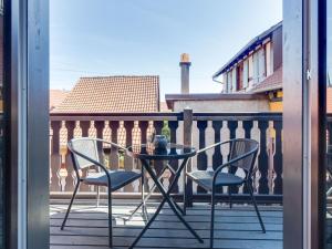 a glass table and two chairs on a balcony at Stunning Apartment in heart of Dambach La Ville in Dambach-la-Ville