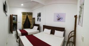 Voodi või voodid majutusasutuse Dive beach palace toas