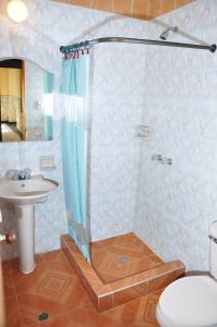 a bathroom with a shower with a toilet and a sink at Hotel Bahia Blanca in Santa Marta