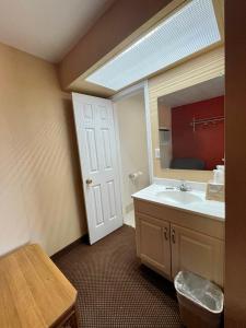 a bathroom with a sink and a mirror at Red River Inn in Clarksville +8 photos
