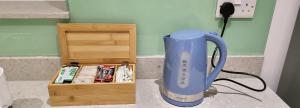 a blue blender sitting on a counter next to a box at Garland Stylish Apartment 1 in Greater London in London