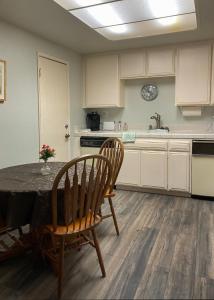 a kitchen with a table and chairs and a sink at Catalina's Got Cart Condo in Avalon