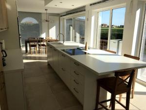 a kitchen with a large island with a counter top at Charming Home with Garden in Zuienkerke