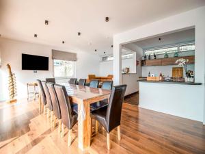 a dining room and kitchen with a table and chairs at Beautiful holiday home in Huy with a terrace in Huy