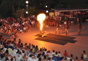 a crowd of people watching a show with a fire performer at Centro Turistico Akiris in Nova Siri Marina +41 photos