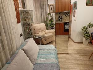a living room with a couch and a mirror at Bright apartment at a great location in Sofia