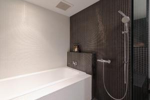 a bathroom with a shower and a bath tub at Kira Kira Suites by H2 Life in Kutchan +35 photos