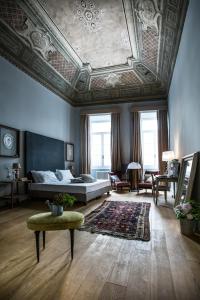 a bedroom with a bed and a coffered ceiling at Soprarno Suites in Florence