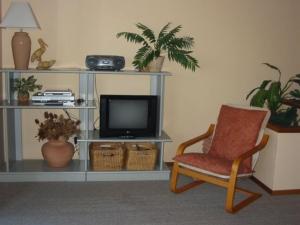 sala de estar con silla y TV en Coastal Retreat Unit 3, en Sunshine Bay