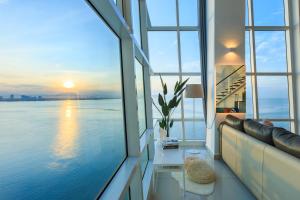 a living room with a couch and a view of the water at Maritime in George Town