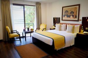 a hotel room with a large bed and a window at Fox Jaffna in Jaffna