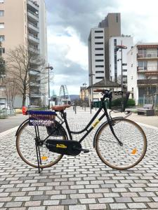 a bike parked on a sidewalk in a city at Modern Living in Huningue