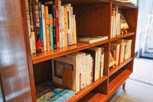 a book shelf filled with lots of books at KéFU stay & lounge in Kyoto
