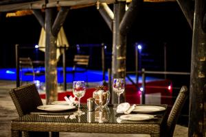 a table with glasses and napkins on top at Uukwaluudhi Safari Lodge in Okahao
