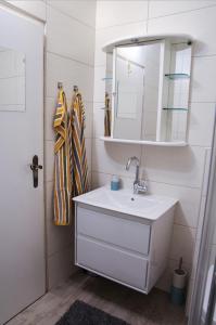 a bathroom with a white sink and a mirror at Studio-Appartement Drei Hörndl in Bad Hofgastein +16 photos