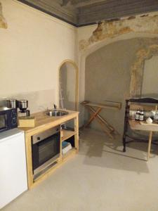 Historische Renaissance-Stube Kahla في Kahla: مطبخ مع مغسلة وطاولة فيه