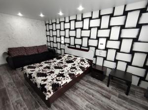 TuymazyにあるSutki 700 Komarova 28のベッドルーム1室(ベッド1台、白黒の毛布付)