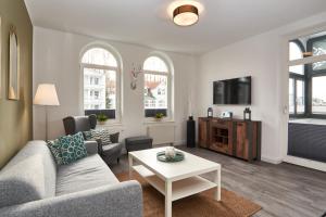 a living room with a couch and a table at Haus am Meer Sellin App 5 und 6 by Meine Ferienzeit in Ostseebad Sellin