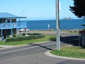 a house on the side of a road next to the ocean at Sandy Place on Long Beach in Long Beach