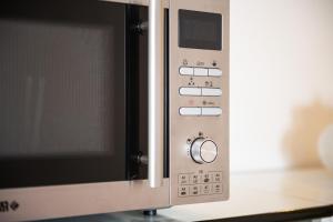 a microwave oven with its door open on a counter at Casa delle Poiane Costa Rei in Monte Nai