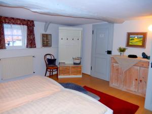a bedroom with a bed and a desk and a chair at Visavis Villa Velo in Jestädt