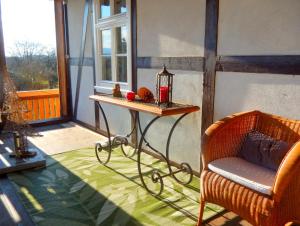 a room with a table and a chair on a balcony at Visavis Villa Velo in Jestädt