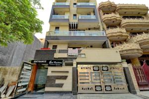 a tall building with a store in front of it at Goel Residency in New Delhi