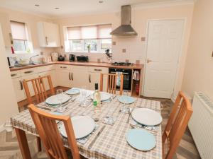 a kitchen with a dining table with chairs and a table and chairsktop at Gough Bank in Bridlington