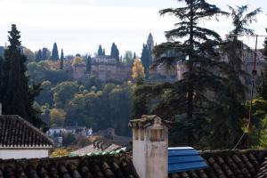 a view of a castle from the roofs of houses at Mirador Alhambra - 2 Private Terraces - Wifi - in Granada