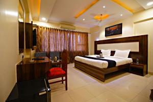 Habitación de hotel con cama y escritorio en Hotel Mina International, en Bombay