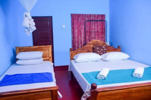 Postel nebo postele na pokoji v ubytování Relax Guest House Dambulla