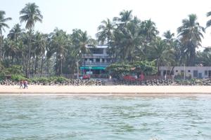 a house on the beach from the water at Hotel Chivla Paradise in Malvan