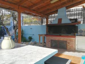 a outdoor patio with a fireplace and a table at AROKARIA HOUSE in Kanakia