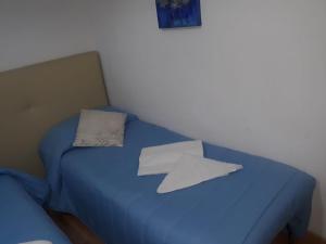 A bed or beds in a room at AFFITTACAMERE Il Cortile