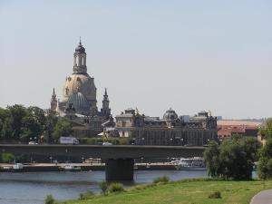 a bridge over a river with a city in the background at Z Testhotel Zur Sonne in Dresden