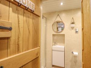 a bathroom with a sink and a mirror at Ty Gwyn Cottage in Llysfaen +34 photos